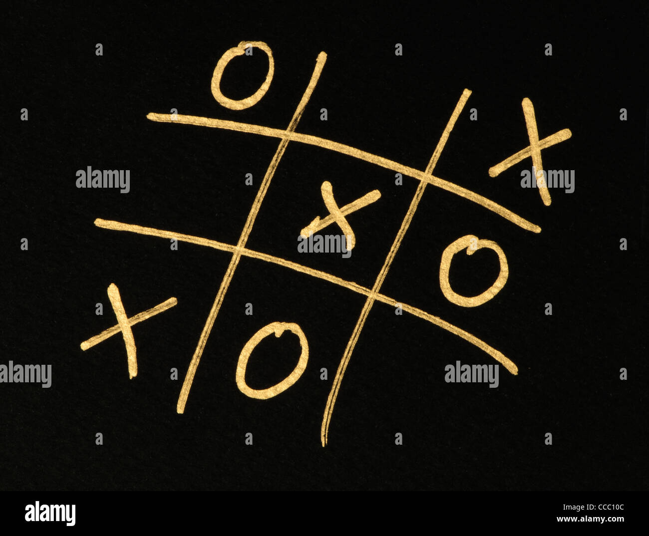 Hand-drawn tic-tac-toe game. Gold color text over black Stock Photo - Alamy
