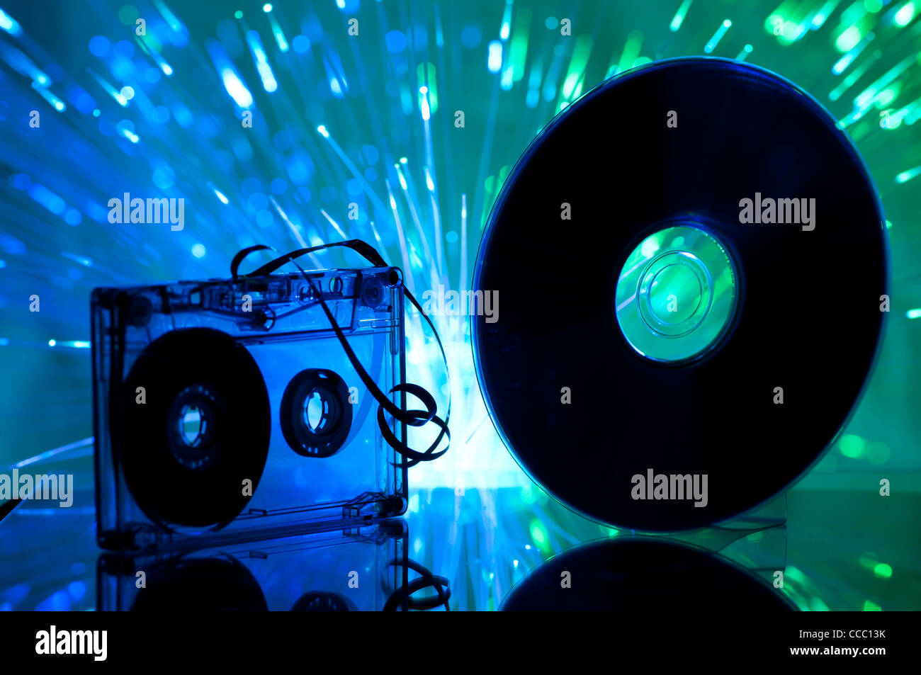 Cassette tape and CD. Multicolored blue lights on background Stock Photo