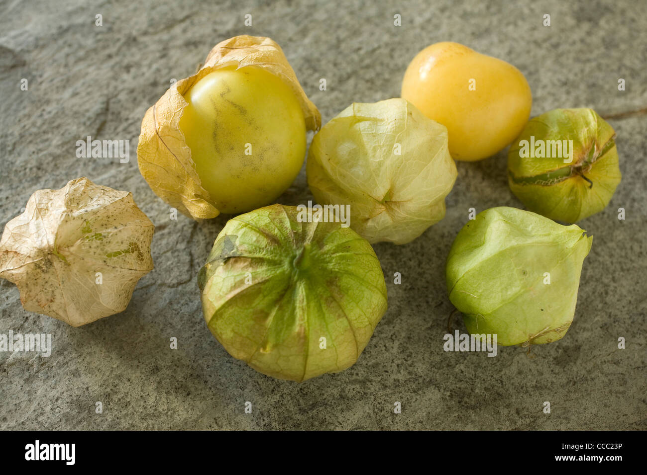 A group of fresh tomatillos, often used in Mexican cuisine, sit on a