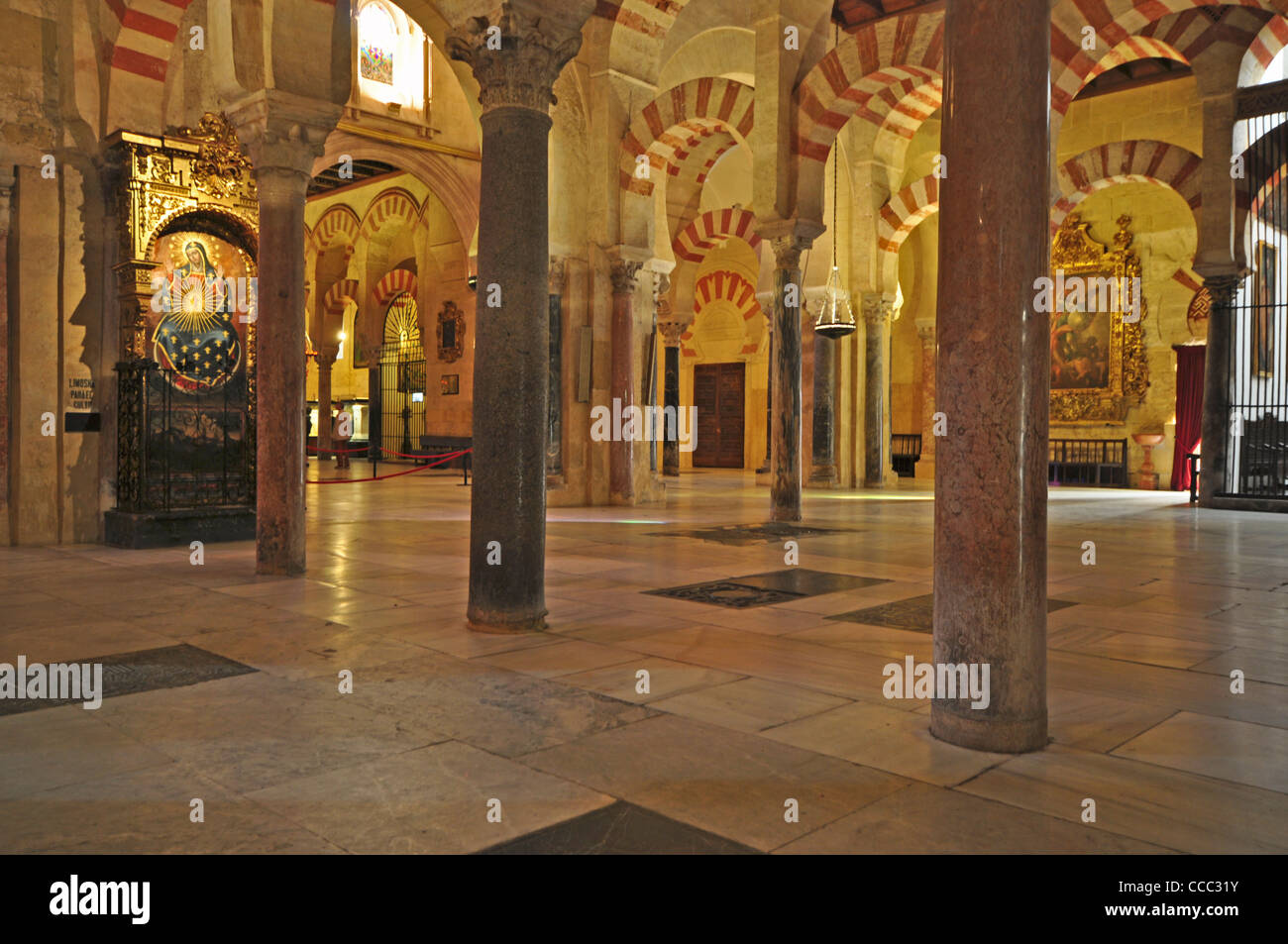 EUROPE, SPAIN, Cordoba, Mezquita (originally 8th Century Mosque), interior with Moorish arches and picture of the Virgin on left Stock Photo