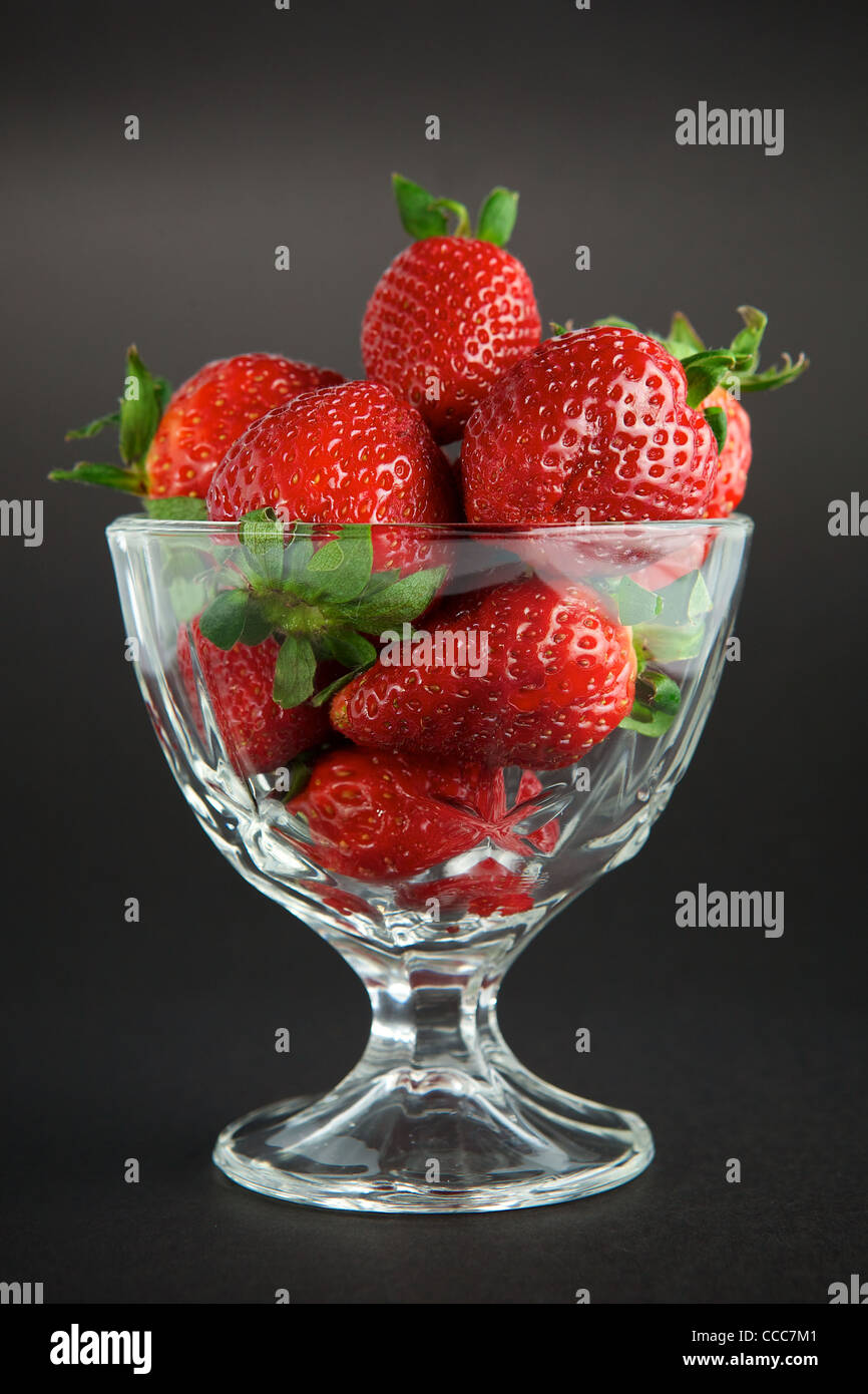 Strawberry in glass container on black background Stock Photo