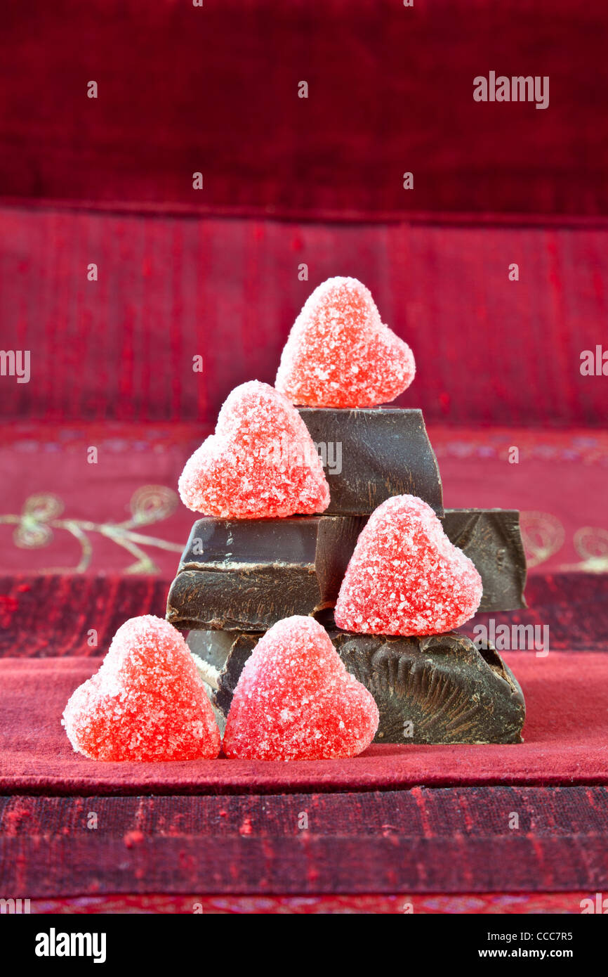 Jelly (gummy) sugar coated candy hearts arranged on top of pile of