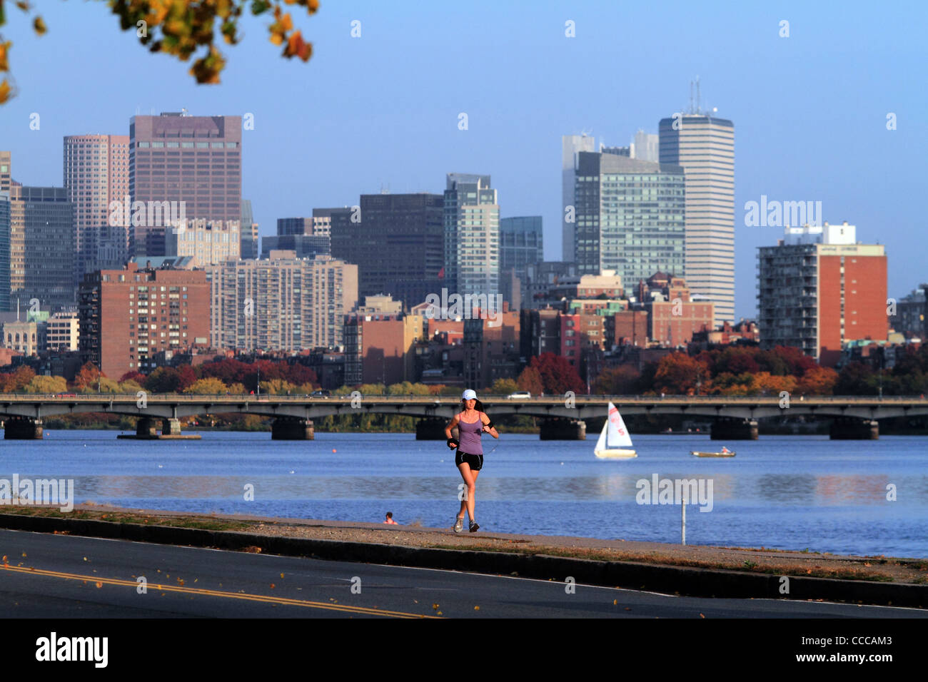 Female jogger runs near Harvard Bridge along Charles River in Cambridge, Massachusetts October 2010. Stock Photo