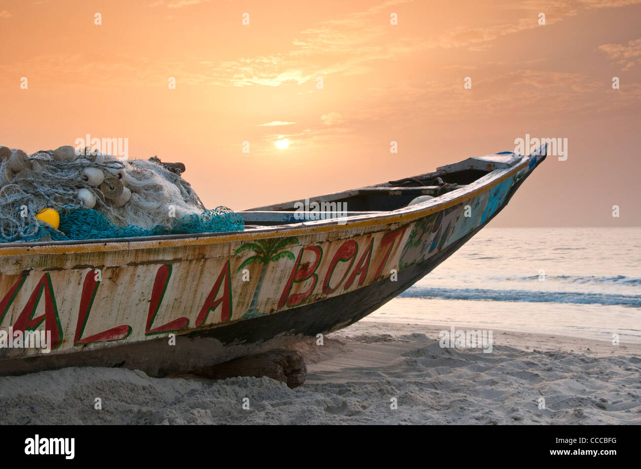 Gambian Fishing Boat on Kololi Beach at Sunset, Near Serekunda, The Gambia, West Africa Stock Photo