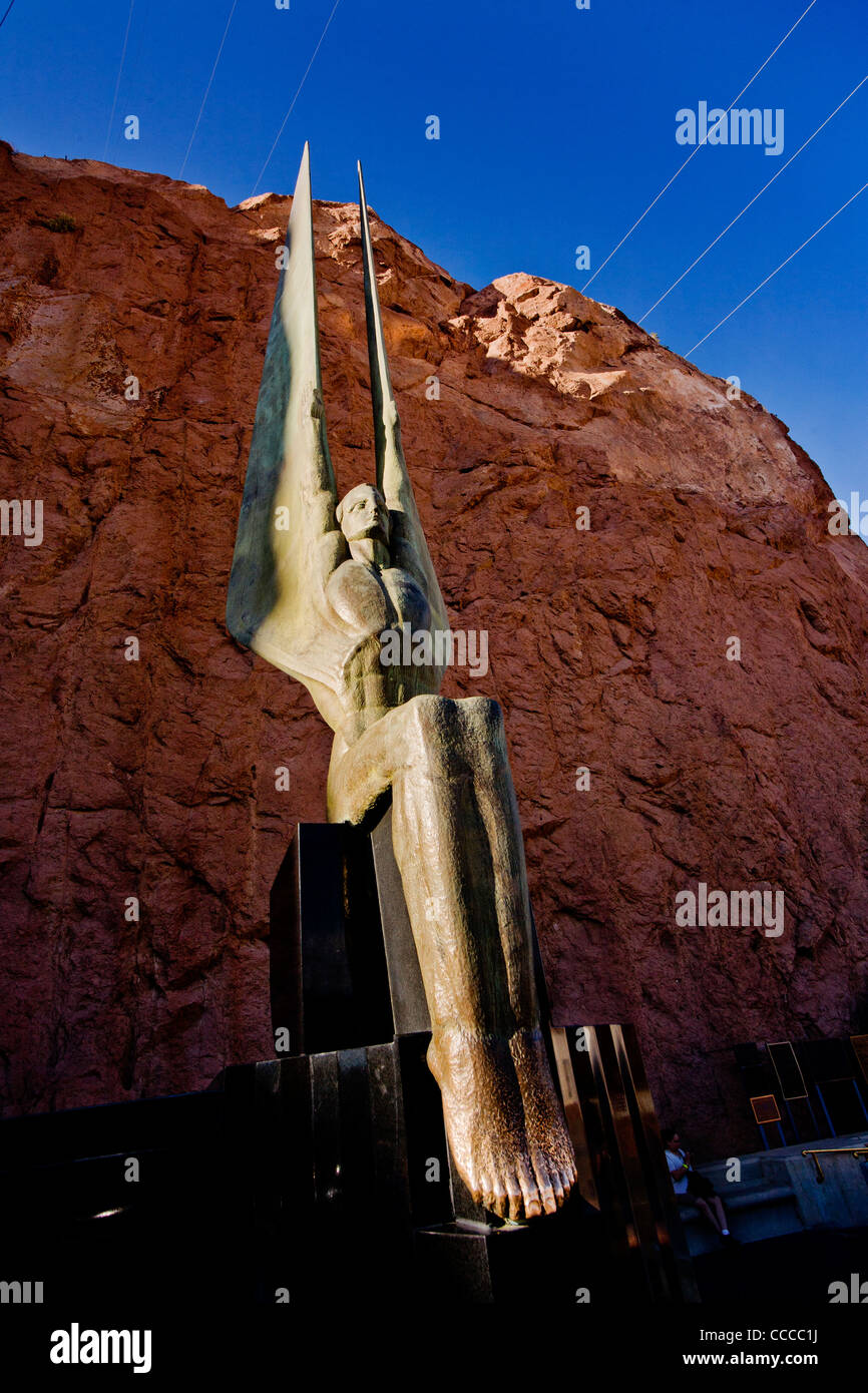 Setting sun illuminates one of the two bronze 'Angels Statues' by sculptor Oskar Hansen decorating Hoover Dam on the Colorado. Stock Photo