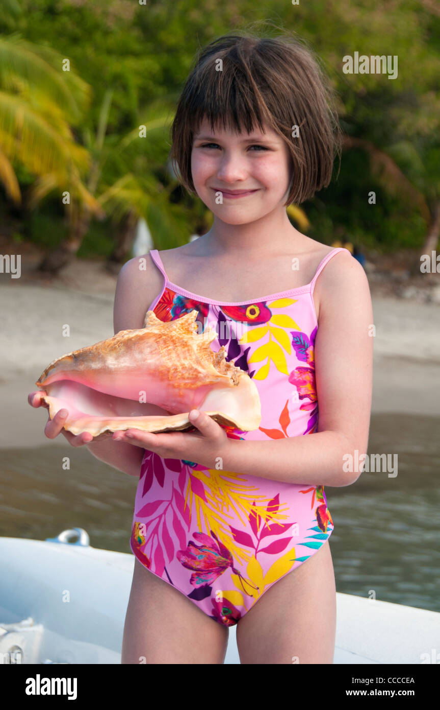 Young Girl with Conch Shell, Anse Couchon Bay, St Lucia, Caribbean Sea, West Indies Stock Photo