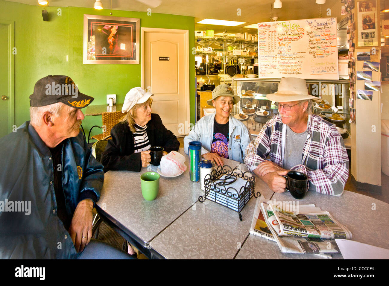 Local people their enjoy morning coffee and conversation at a Main Street restaurant in Kanab, Utah. Note sign in background. Stock Photo