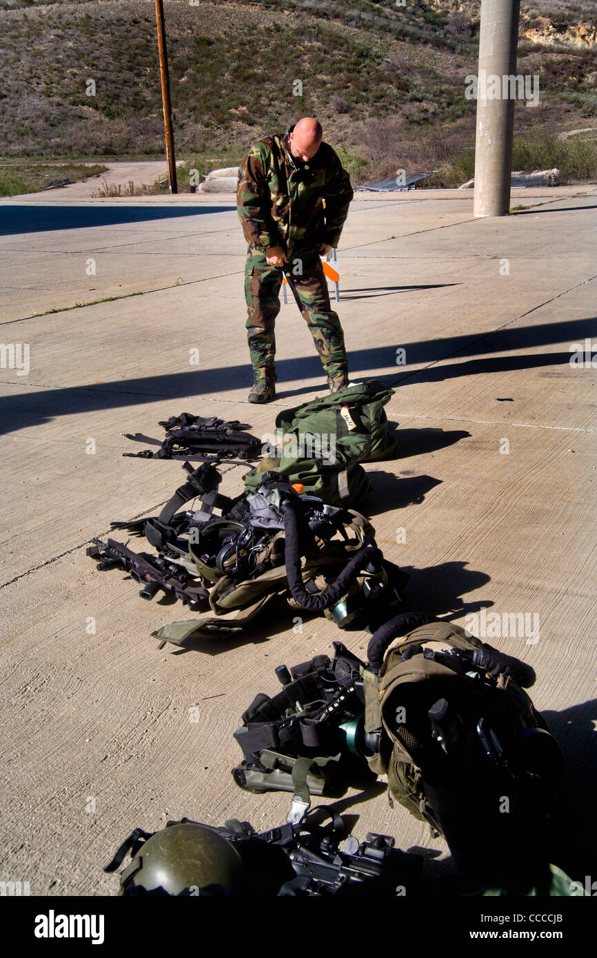 FBI SWAT (Special Weapons and Tactics) team member dons specialized 'Weapons of Mass Destruction' equipment for training drills Stock Photo