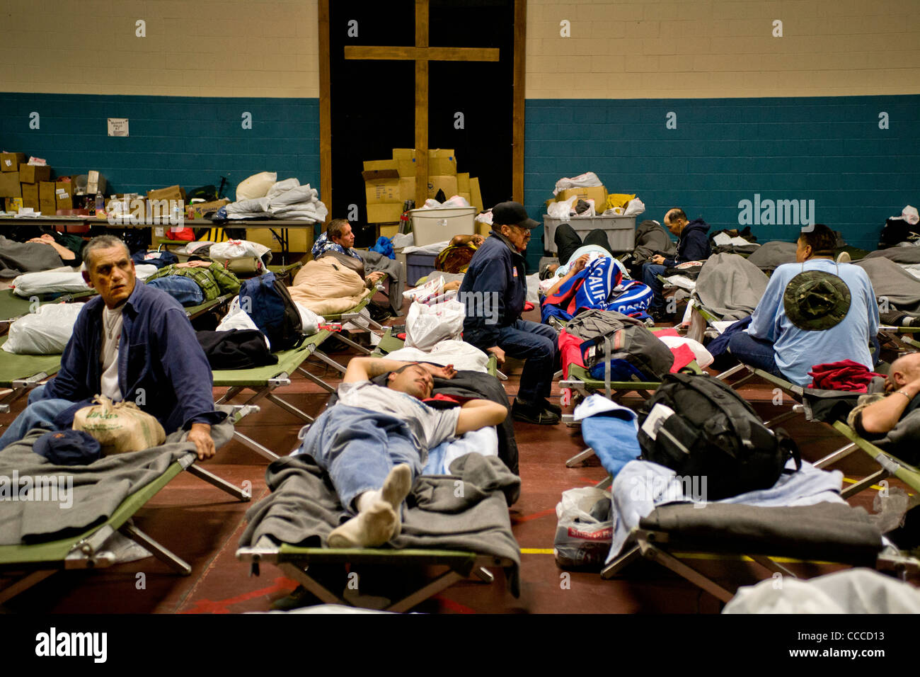 Homeless men prepare to sleep at a night shelter held at a church in