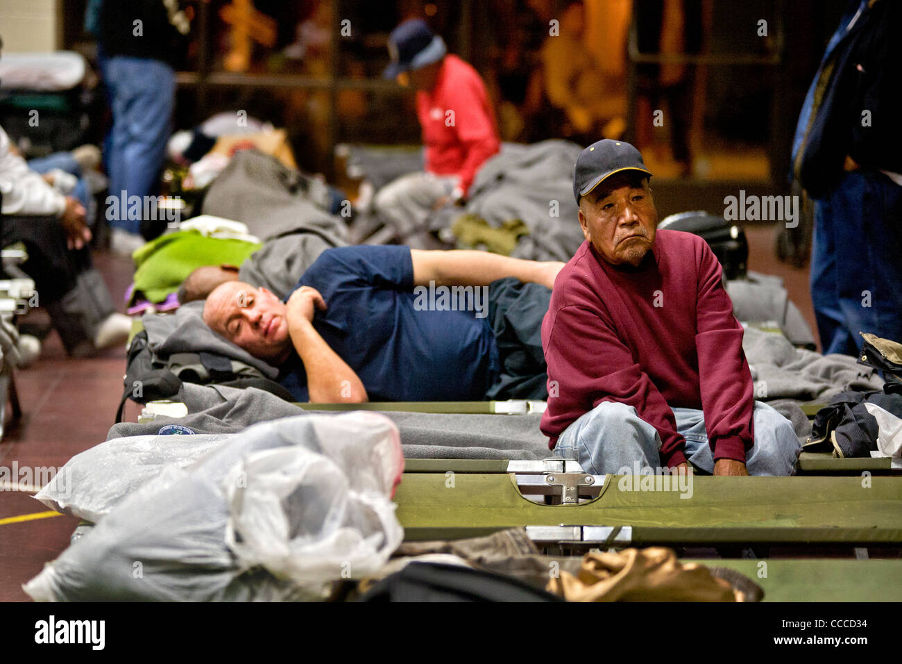 Homeless men prepare to sleep at a night shelter held at a church in