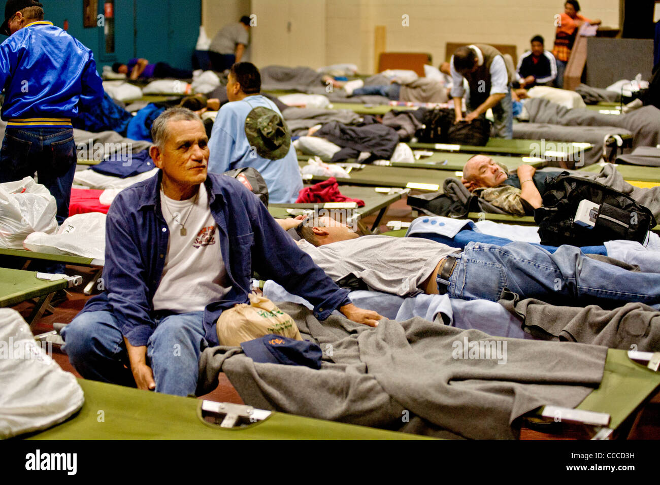 Homeless men prepare to sleep at a night shelter held at a church in