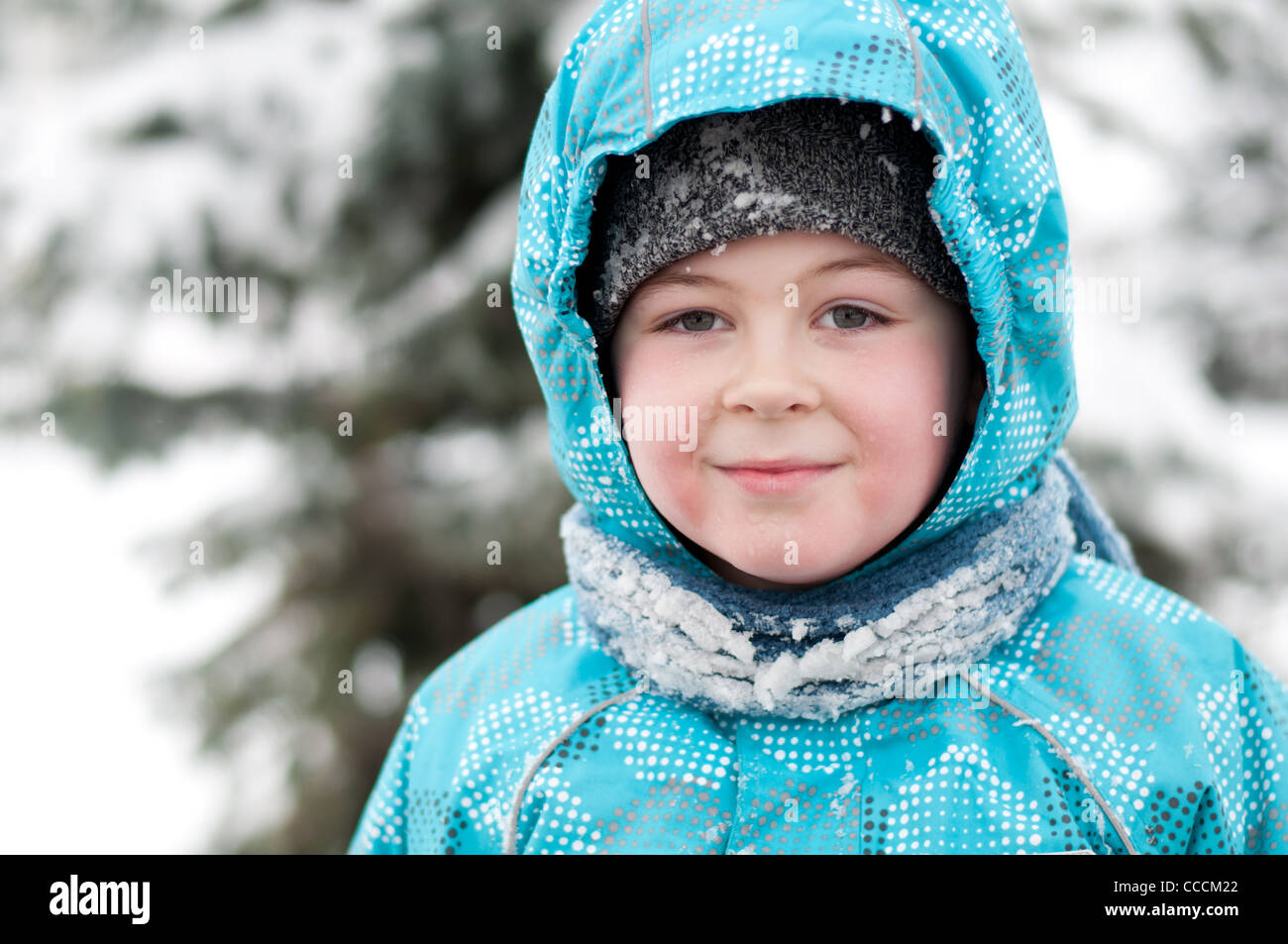 portrait boy child 7 8 9 year winter snow wet drops jacket hood scarf one cute handsome serious Russia cold frost freezing happy Stock Photo