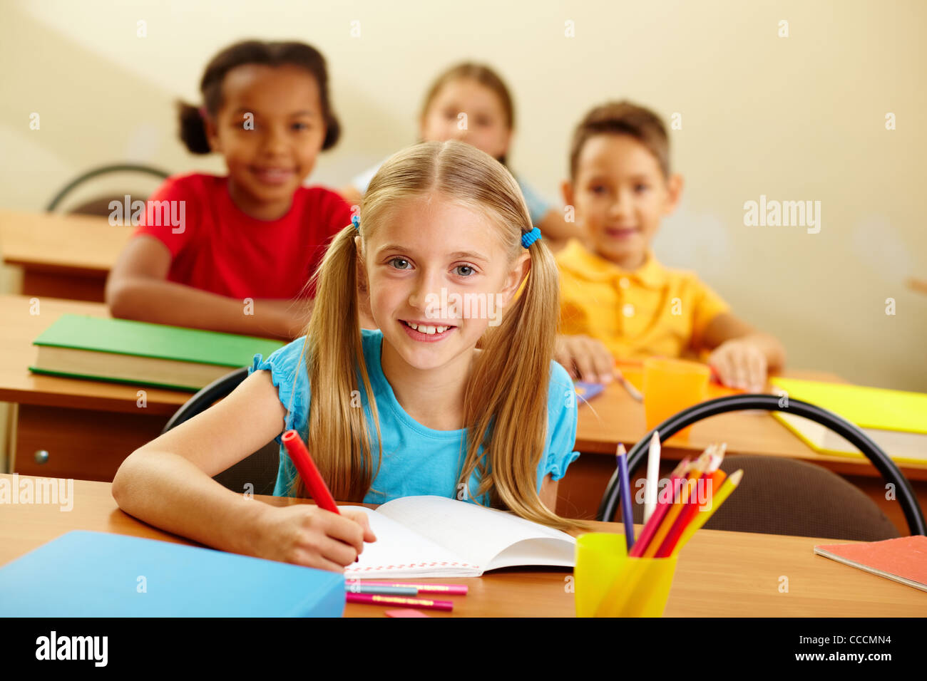 Portrait of lovely girl looking at camera at lesson Stock Photo - Alamy