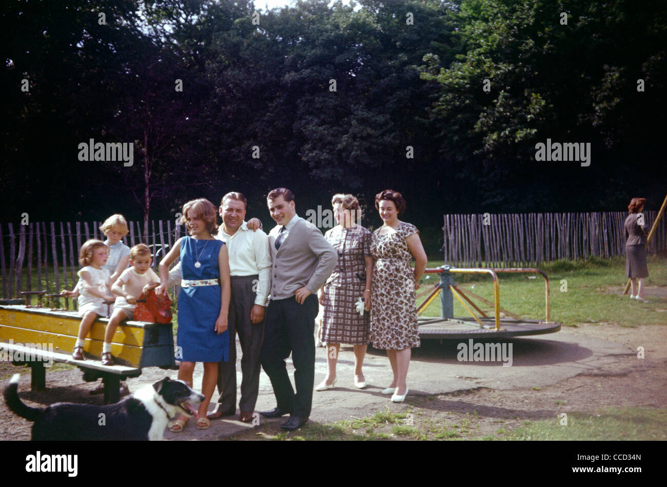 Families and friends have their photo taken in a childrens' playground in the early nineteen sixties. Stock Photo