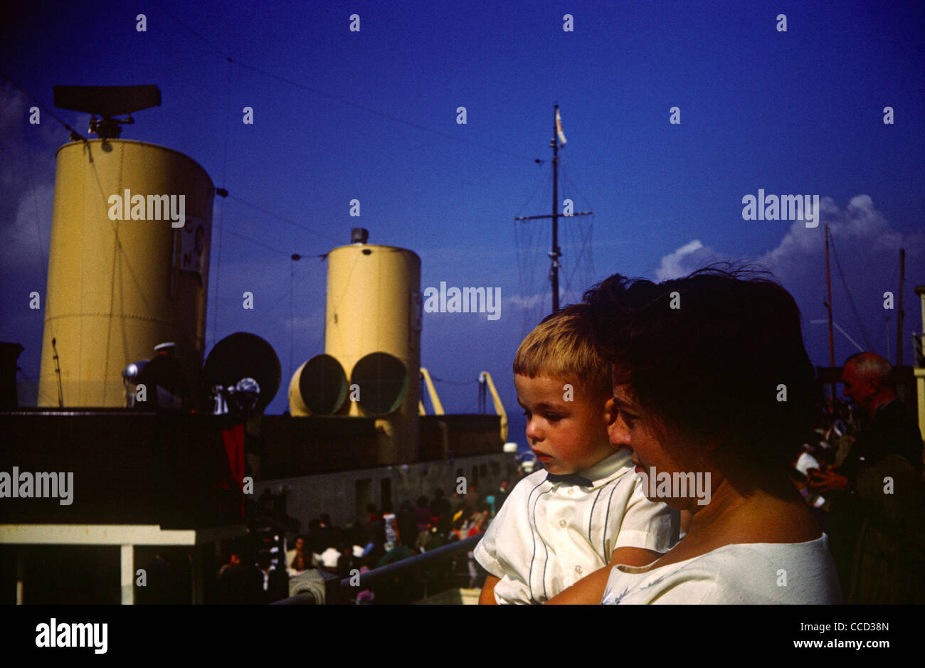 A mother holds her young son up to show him a paddle steamer on Southend pier in the early nineteen sixties. Stock Photo