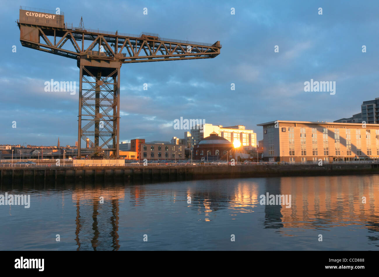 Finnieston (Stobcross) crane and sunrise River Clyde and City Hotel Broomielaw GlasgowScotland Stock Photo
