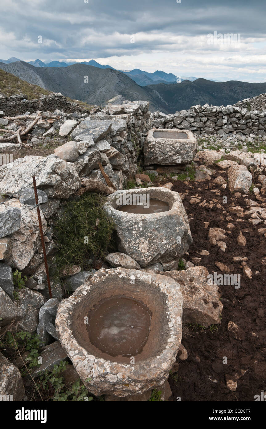 Old stone sinks, used by cowherds in the high pastures of the Taygetus mountains, Outer Mani, Peloponnese, Greece. Stock Photo