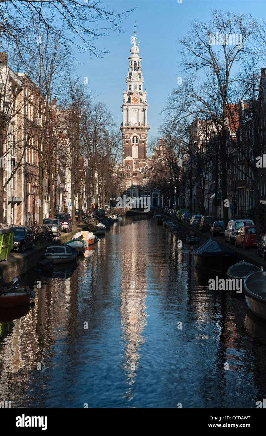 The elaborate tower and spire of the 17c Zuiderkerk church reflected in the water of the Groenburgwal canal in Amsterdam, the Netherlands Stock Photo