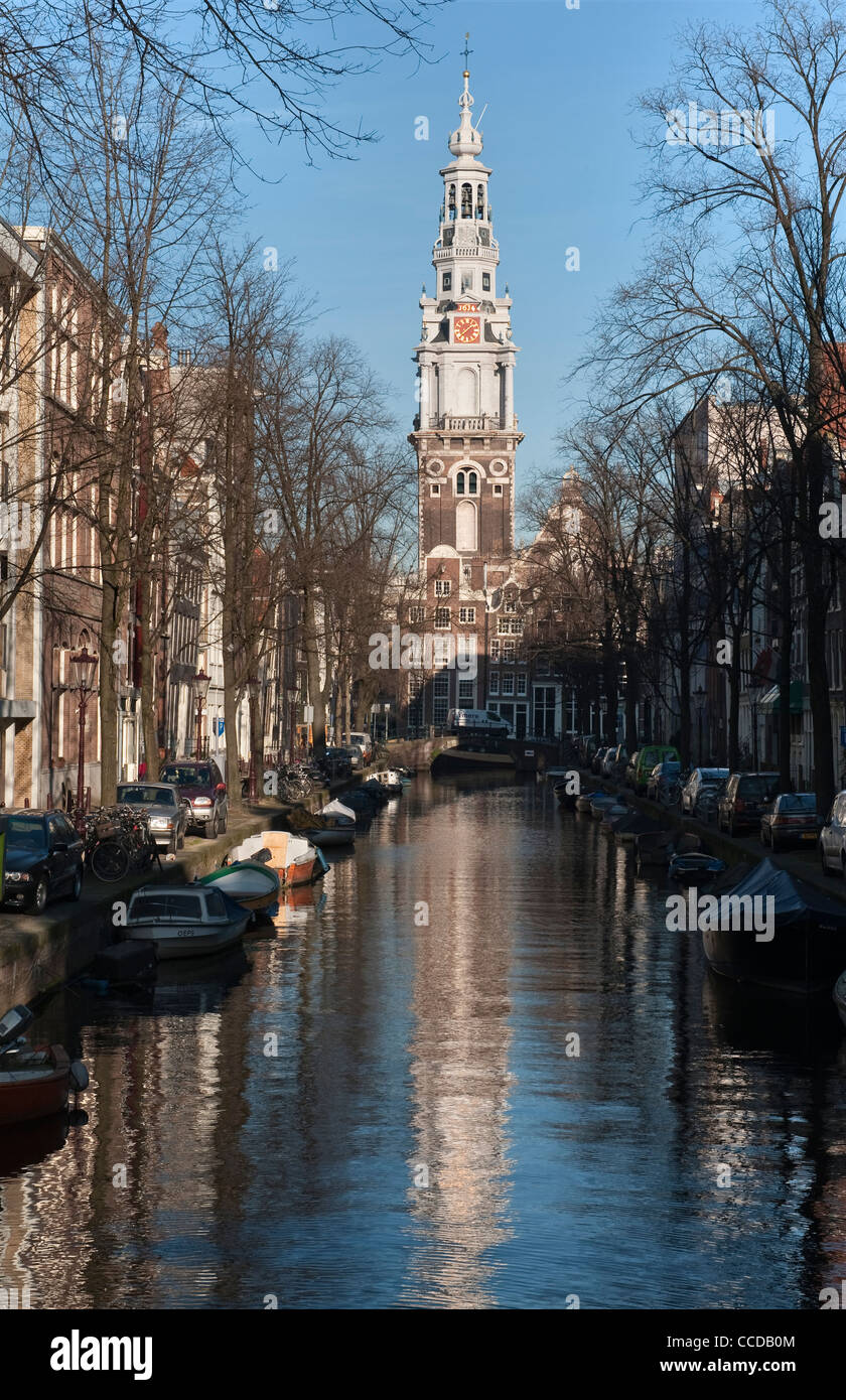 The elaborate tower and spire of the 17c Zuiderkerk church reflected in the water of the Groenburgwal canal in Amsterdam, the Netherlands Stock Photo
