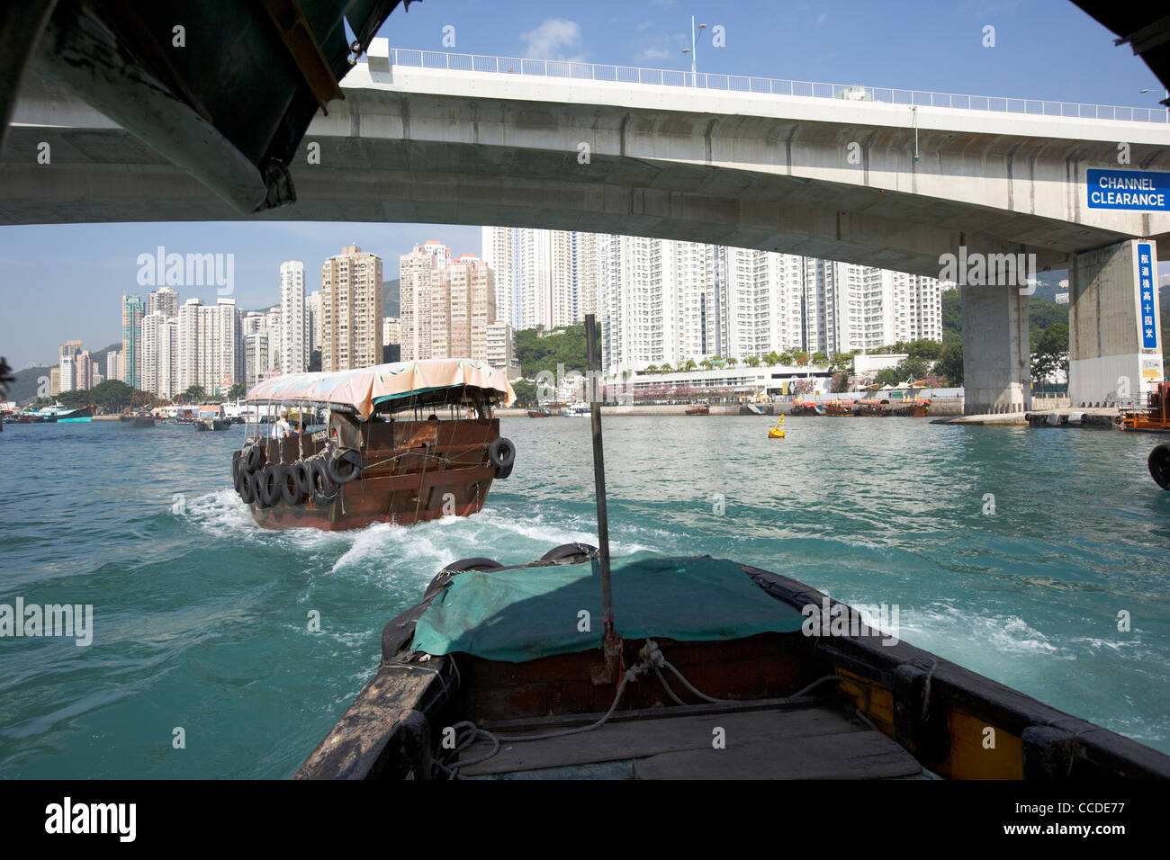 sampan boat trips passing under the ap lei chau bridge in aberdeen harbour hong kong hksar china asia Stock Photo