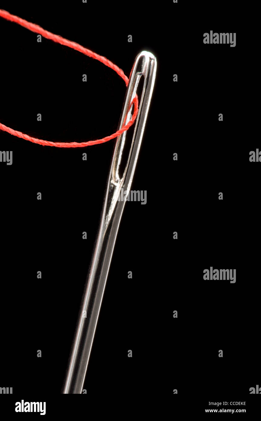 Sewing needle with red thread Stock Photo Alamy