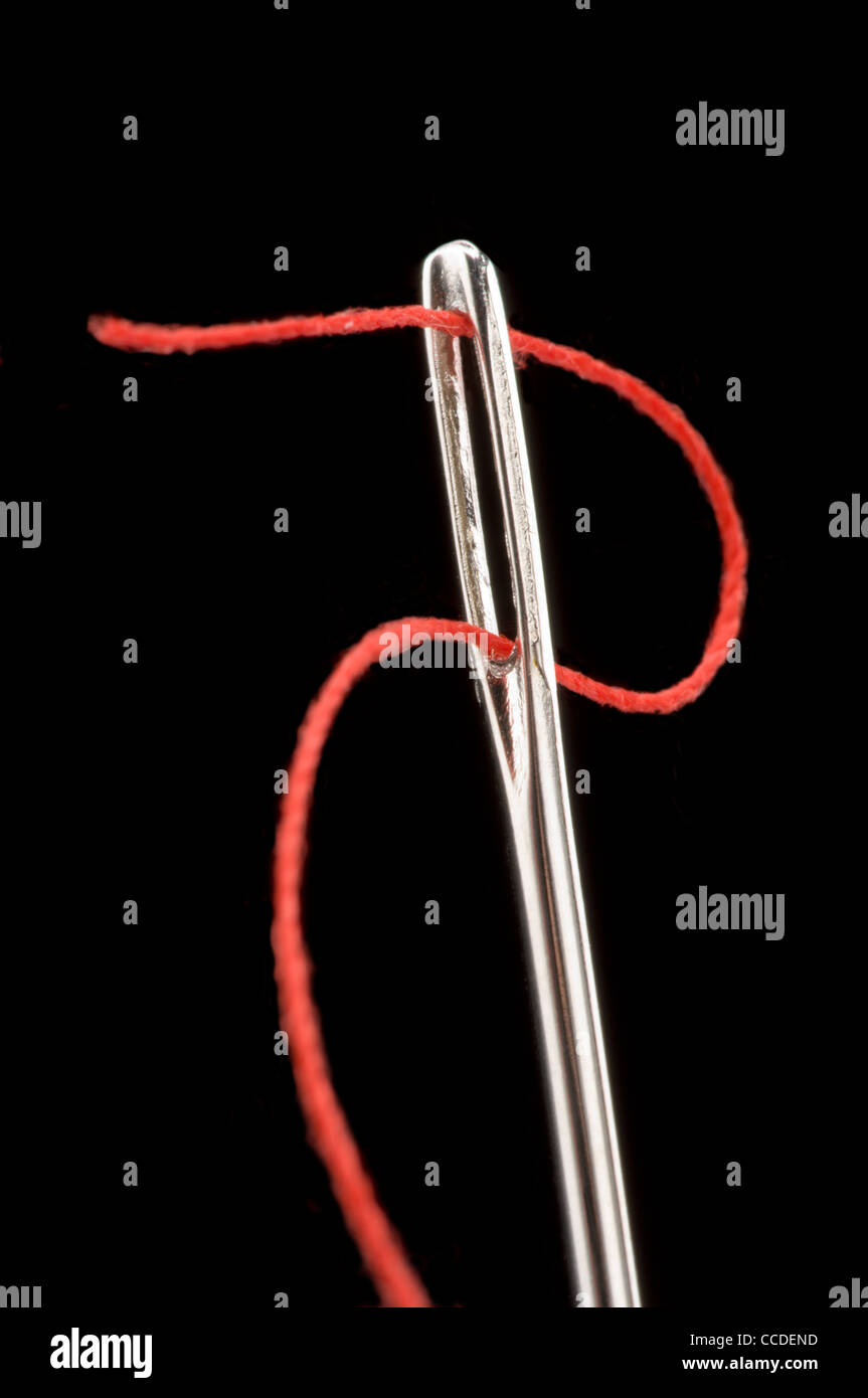 Sewing needle with red thread Stock Photo Alamy