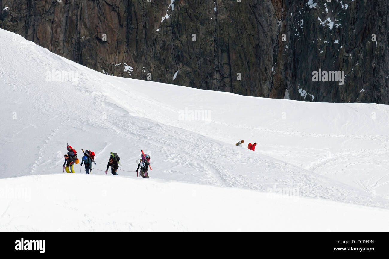 Ski mountaineers ascending snow slope before skiing down of the Mont Blanc in the French Alps, France Stock Photo