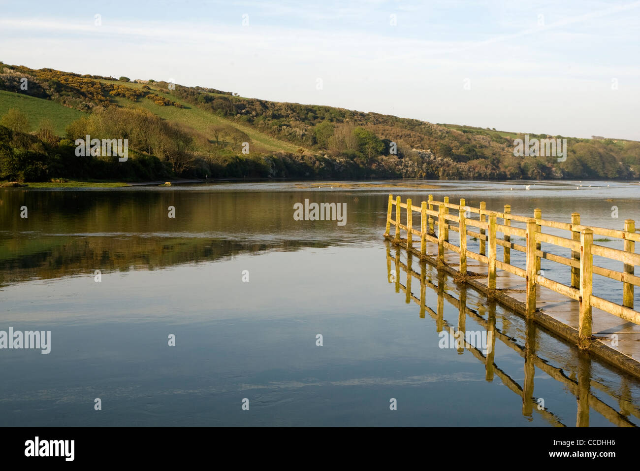 A walkway which is partially submerged by the incoming tide on the River Gannell at Newquay, Cornwall. Stock Photo