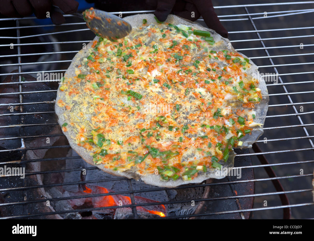 'Banh Trang Nuong' or Vietnamese Pizza at street stall in Dalat Vietnam Stock Photo