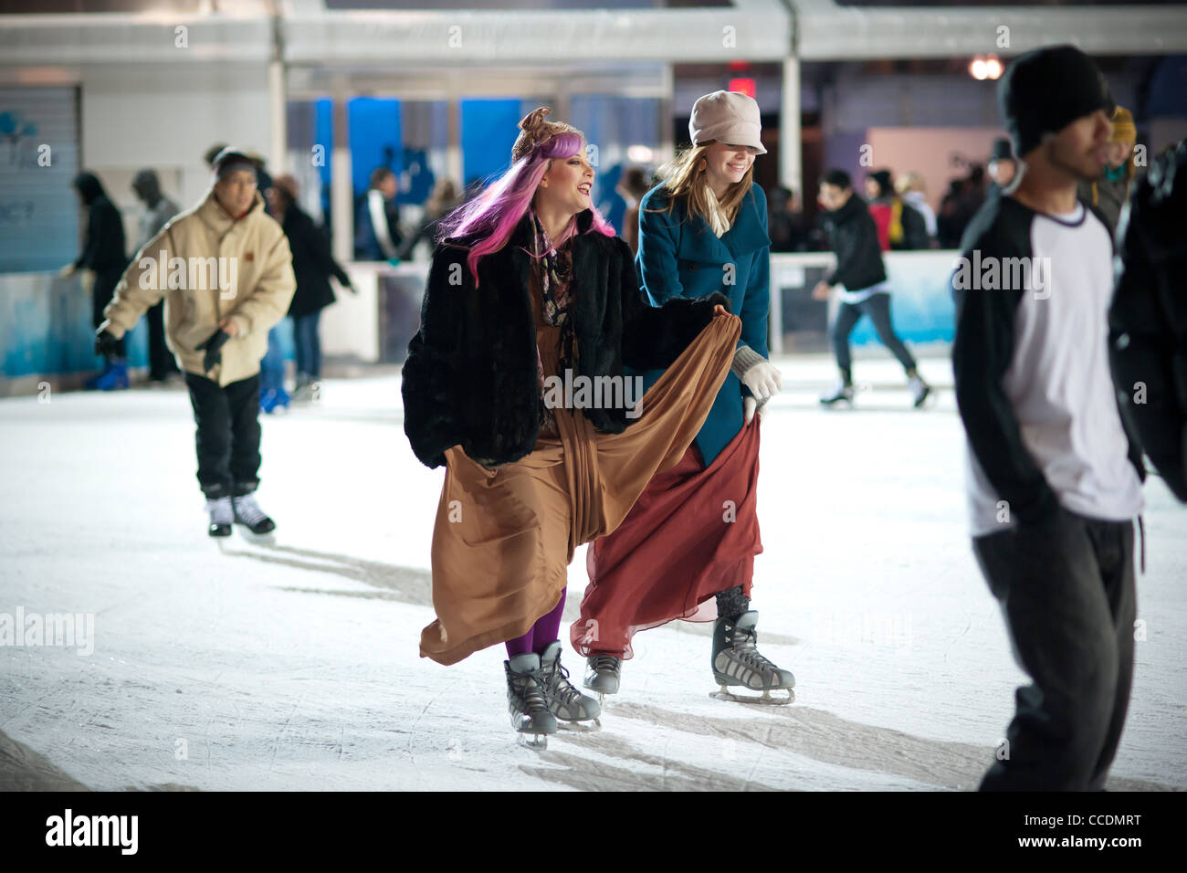 Skaters dressed in formal attire maneuver the packed Pond at Bryant