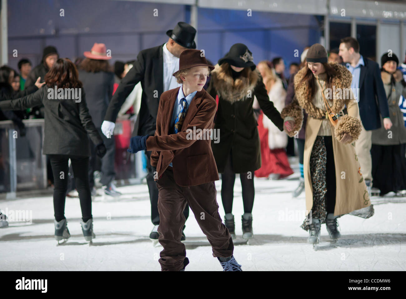 Skaters dressed in formal attire maneuver the packed Pond at Bryant