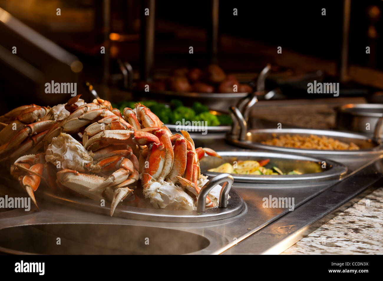 A classy buffet line at a resort's restaurant has crab legs as well as