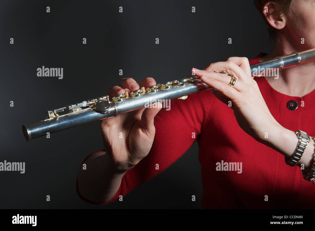 Woman playing flute Stock Photo