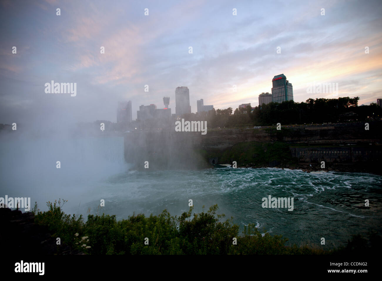 Mist rises from the bottom of Niagra Falls at dusk Stock Photo