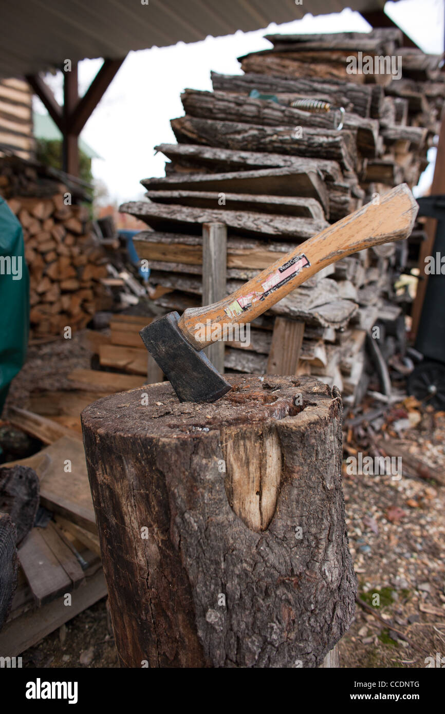 An ax is ready to chop more firewood at a home in North Carolina Stock Photo