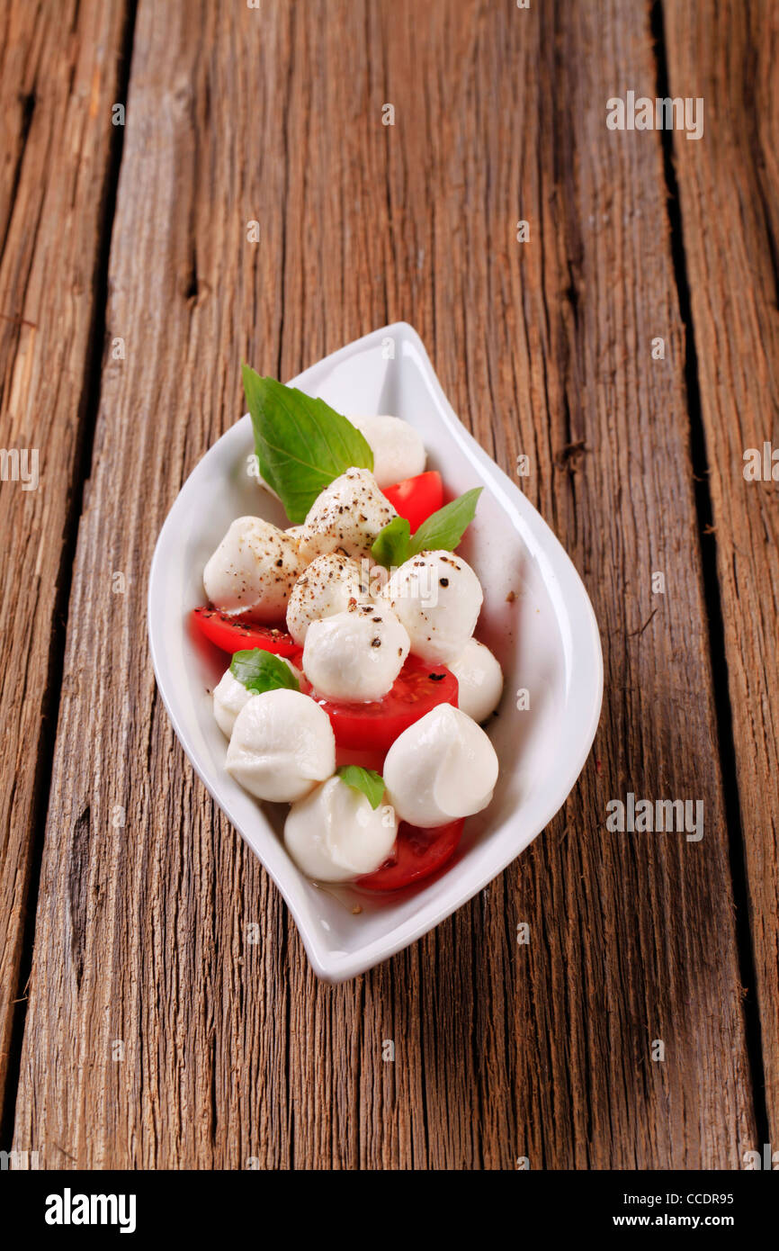 Bowl of mozzarella cheese, tomato and basil Stock Photo - Alamy