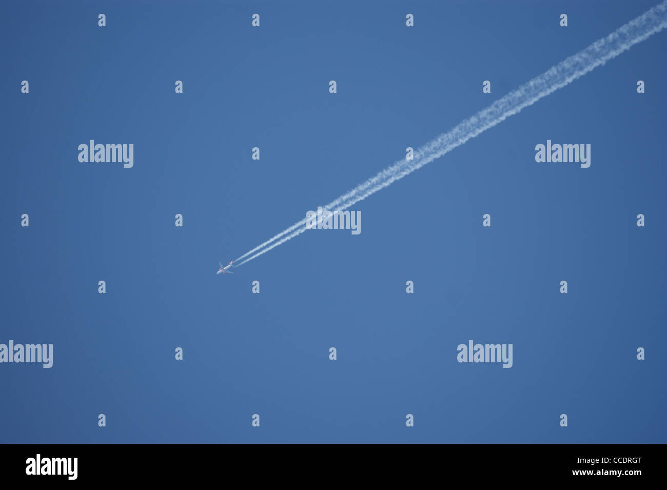 An airplane on a blue sky Stock Photo - Alamy