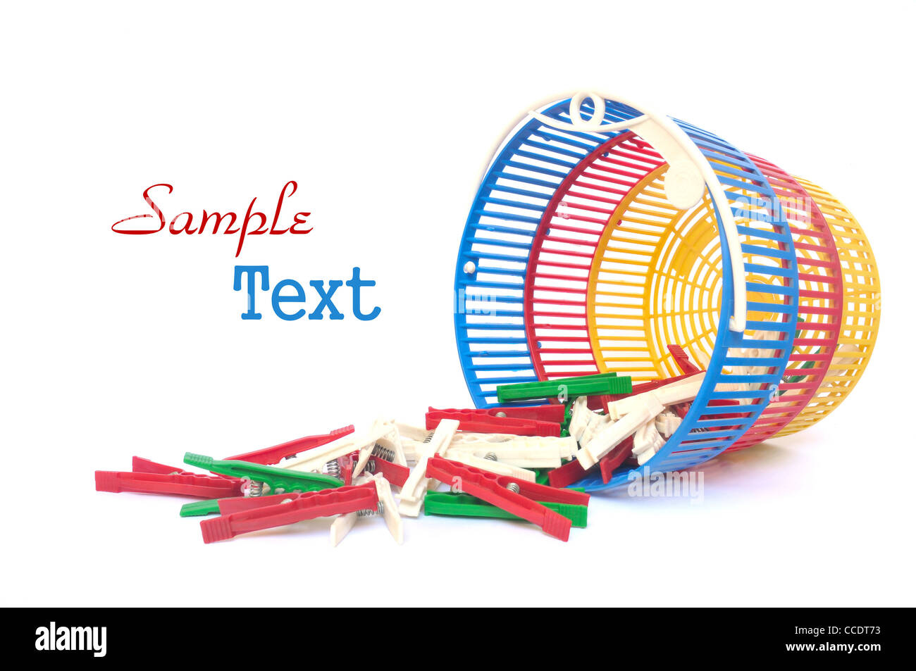 Multicolored clothes pegs in a basket on white background Stock Photo