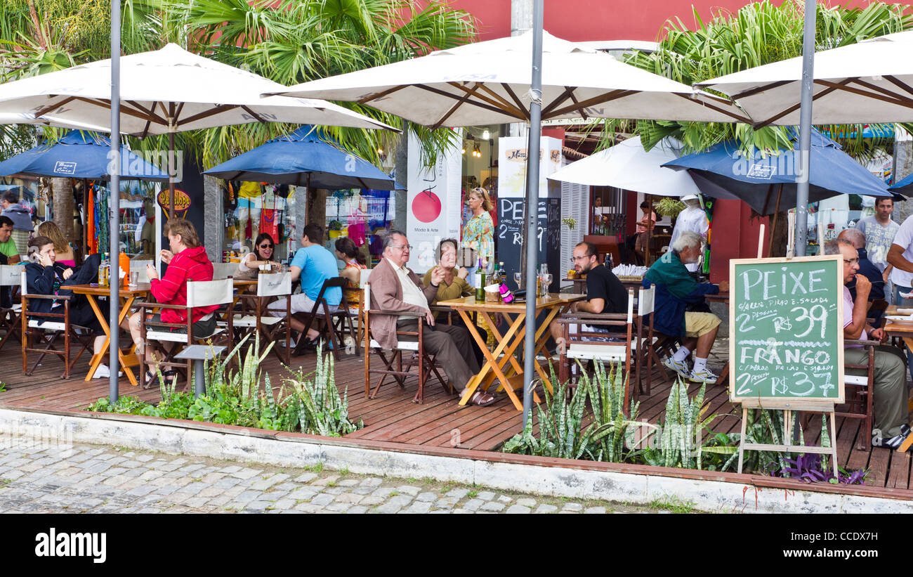 People enjoying a meal at an outdoor restuarant in Armacao dos Buziou Brazil. Stock Photo