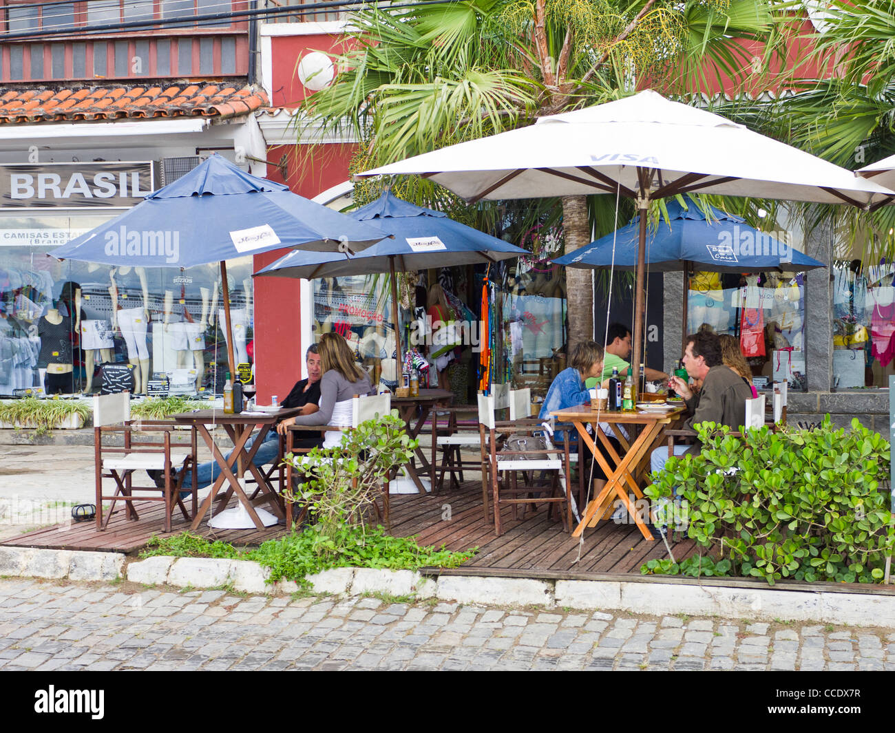 People enjoying a meal at an outdoor restaurant in Armacao dos Buziou Brazil. Stock Photo