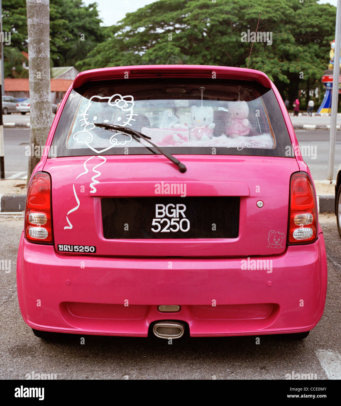 Pink car individuality in Melaka in Malaysia in Far East Southeast Asia. Vivid Colour Colourful Cars Urban Feminine Travel Stock Photo