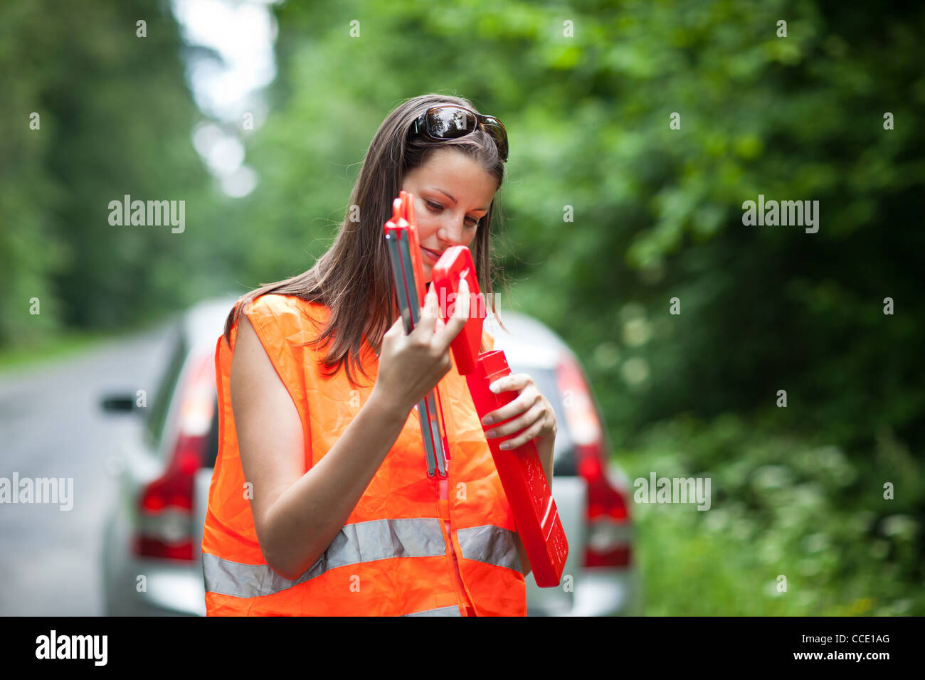 Young female driver after her car has broken down Stock Photo - Alamy