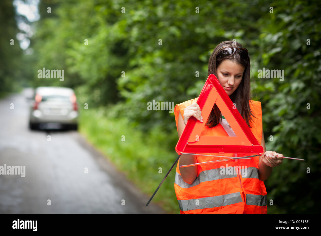 Young female driver after her car has broken down Stock Photo - Alamy
