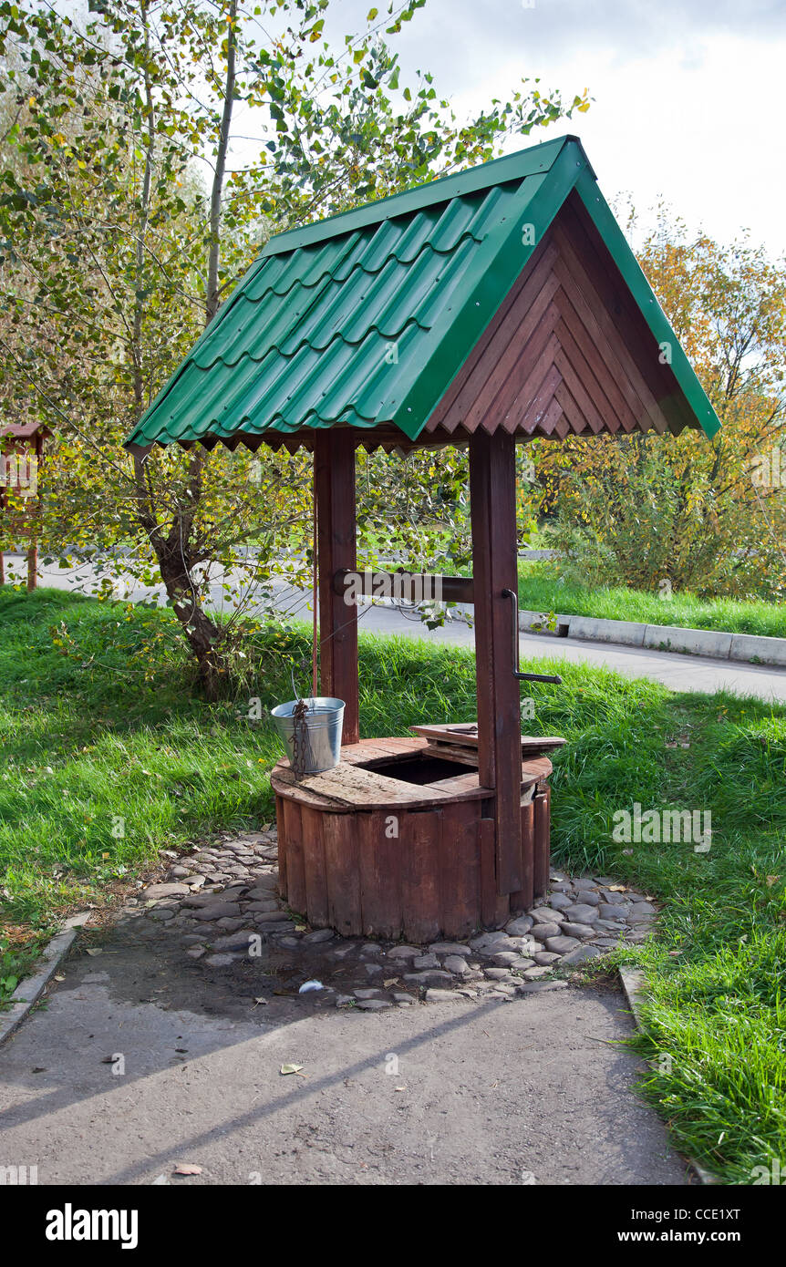Countryside water well with a bucket. Stock Photo