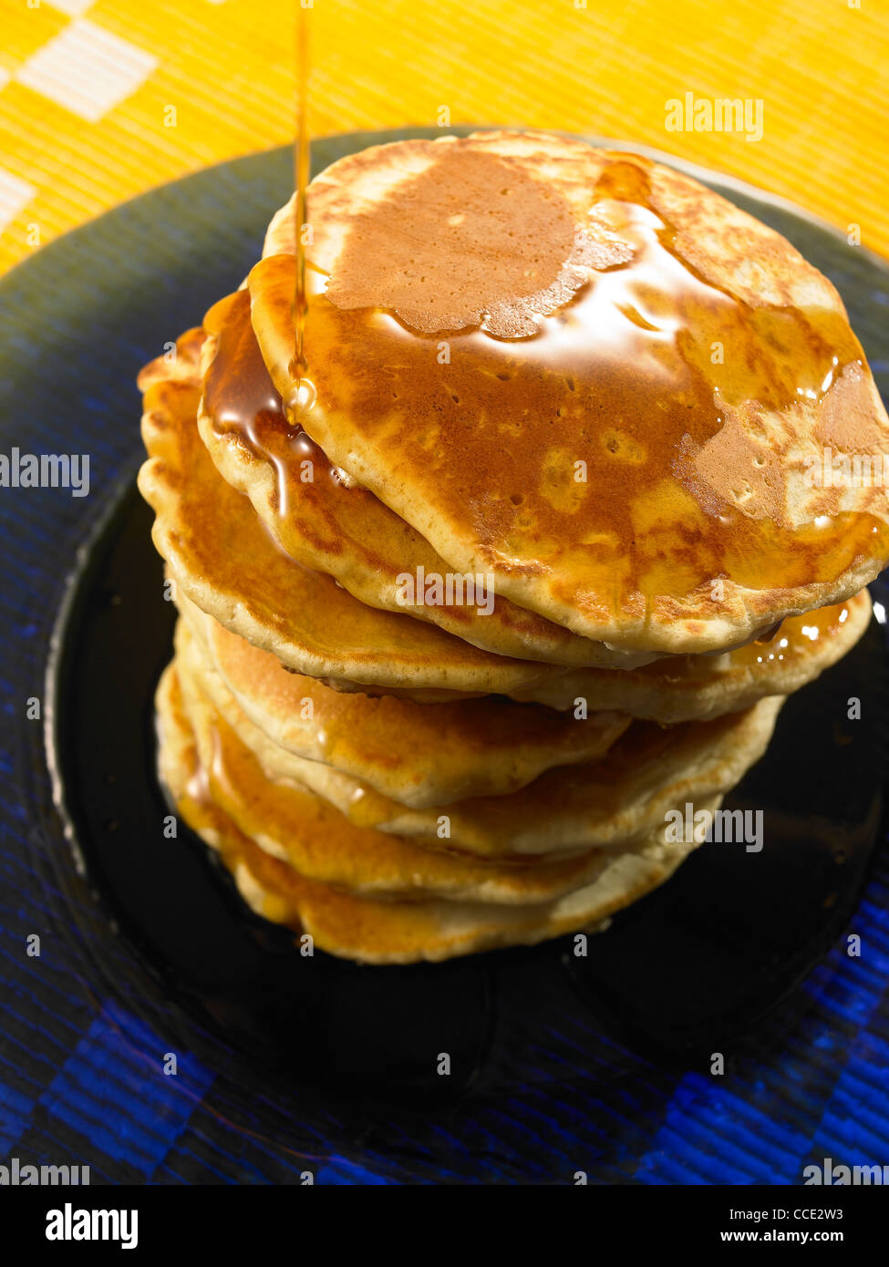 a stack of pancakes with maple syrup pouring on Stock Photo Alamy