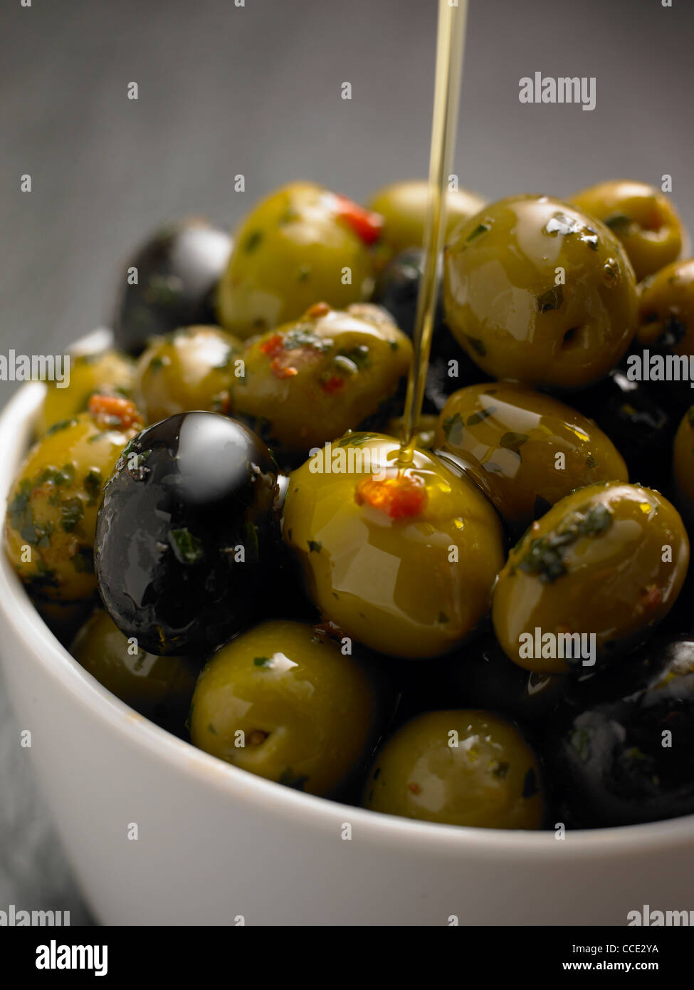 Fresh Olives in a Bowl with olive oil pouring Stock Photo Alamy