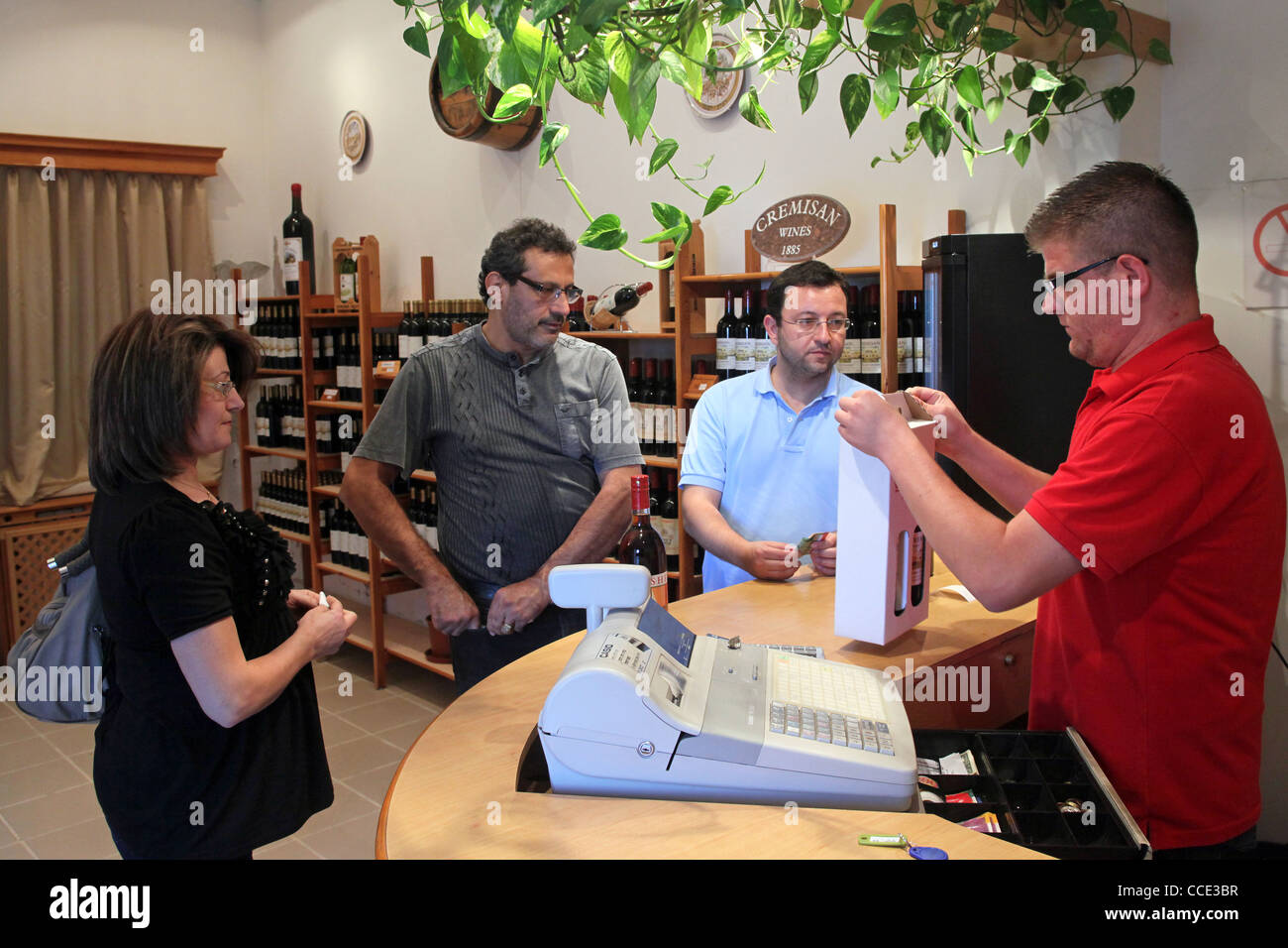 Costumers tasting and buying wine bottles in the store of the cellars of Cremisan Winery in Beit Jala near Bethlehem, Palestine, Stock Photo