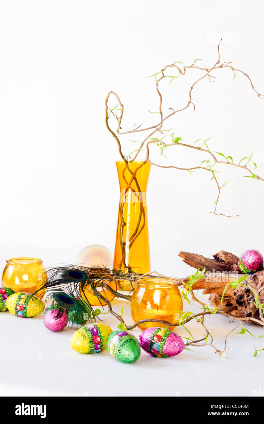 Easter decoration with yellow glass-ware and chocolate eggs - vertical ...