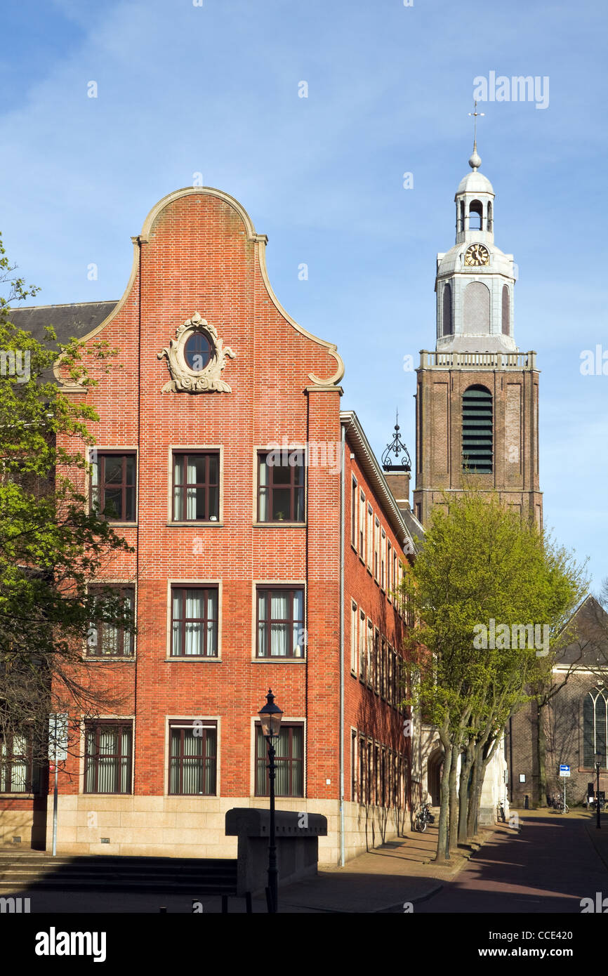 Architectural detail - part of town hall with Dutch gable and old church in background Stock Photo