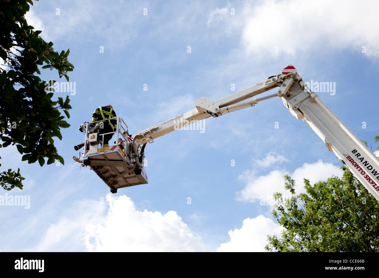 Fire man on ladder of fire engine Stock Photo